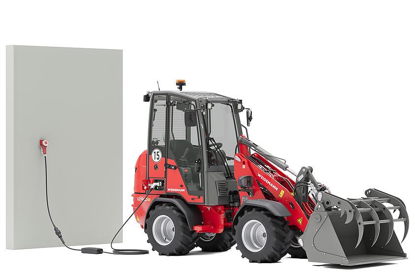 Weidemann Hoftrac 1290e mit Greifschaufel im Studio an einer Ladesäule